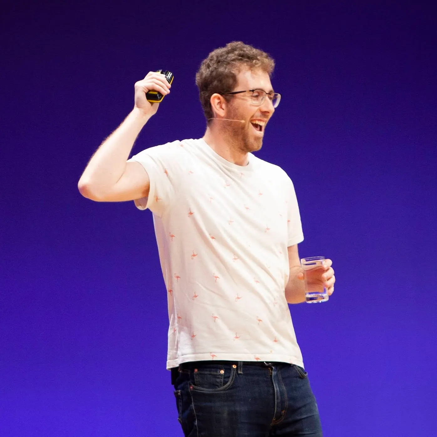 Me smiling happily with my mouth open while giving a talk on stage